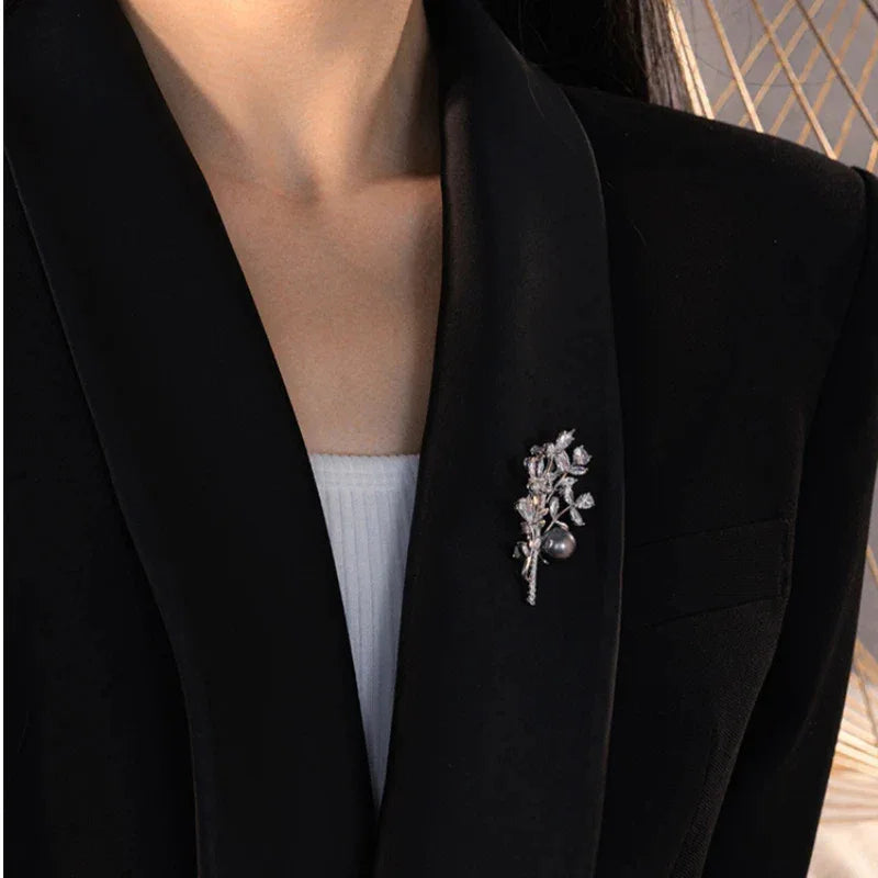 Dark Pearl Leafy Branch Brooch — waist-up model view showing the brooch scale