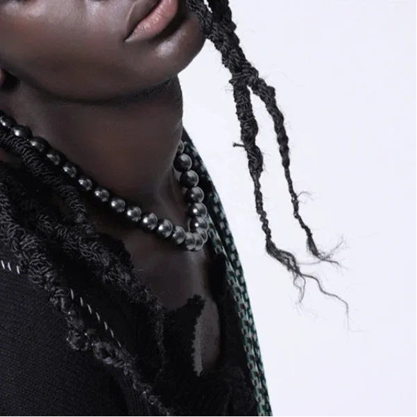Dark Pearl Strand Necklace with Steel Clasp — close neckline-worn view showing the dark pearl color