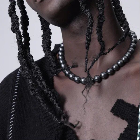 Dark Pearl Strand Necklace with Steel Clasp — necklace worn with layered chains over a distressed black top