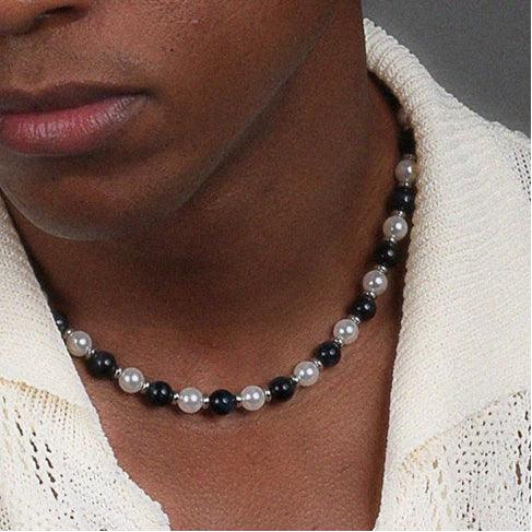 Black Tiger Eye and Pearl Beaded Necklace — neckline-worn view with a light open-knit shirt
