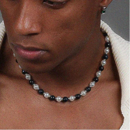 Black Tiger Eye and Pearl Beaded Necklace — front chest-worn close-up over bare skin