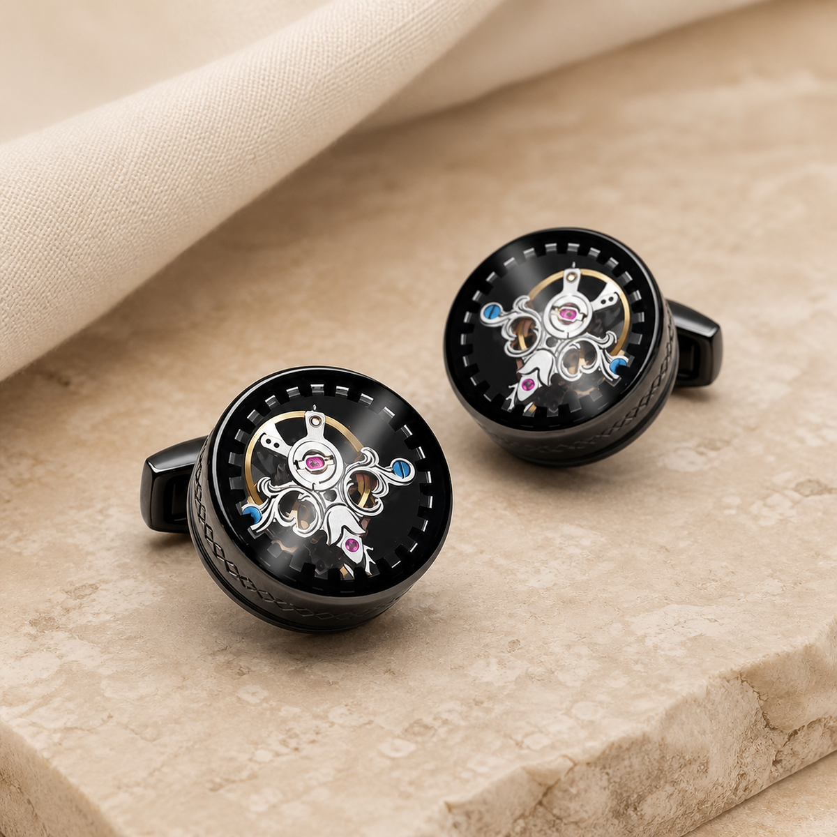 Pair of black round tourbillon clock gear cufflinks displayed on a warm beige tabletop