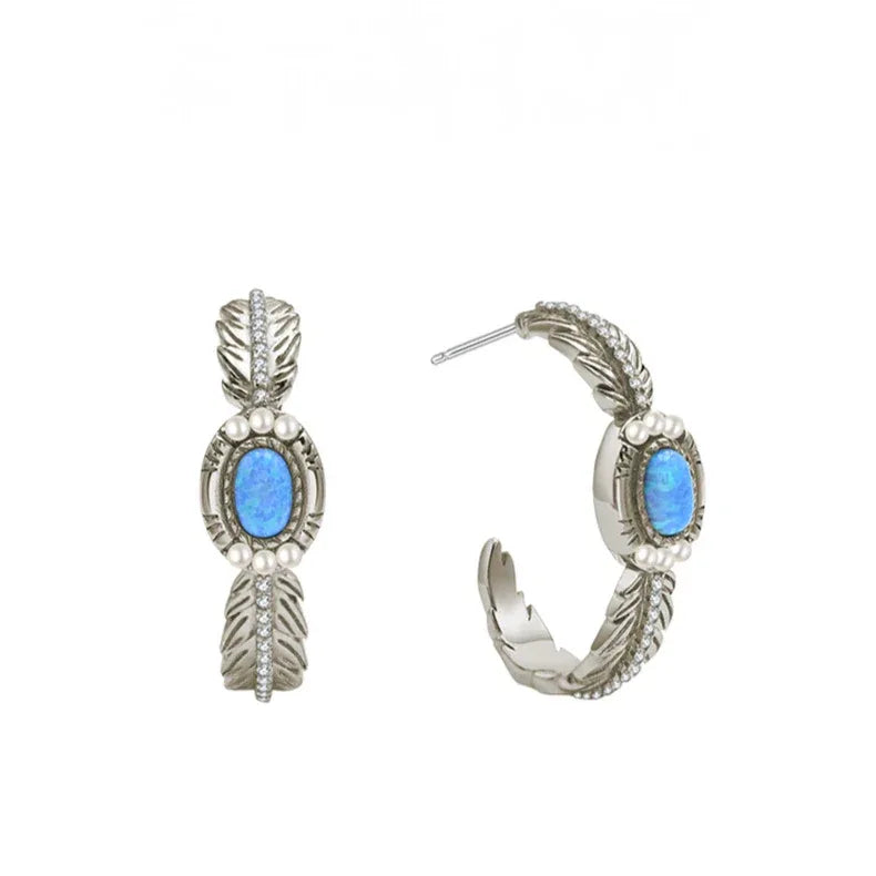 Blue Opal Feather Huggie Hoop Earrings worn on the hand from another angle