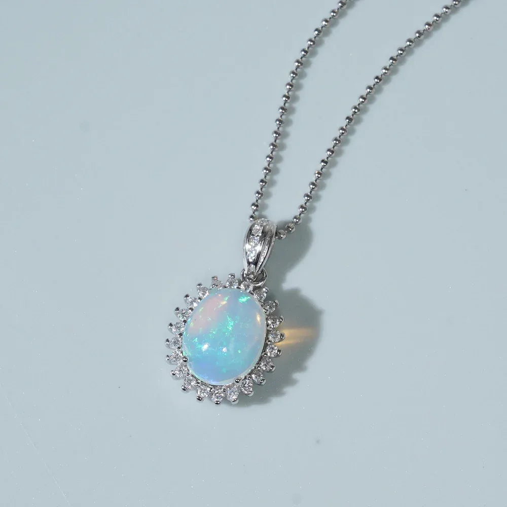 Blue Opal Oval Halo Pendant Necklace worn at the neckline