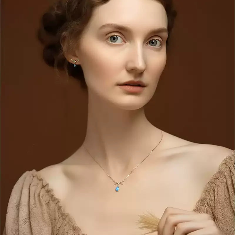 Blue Opal Teardrop Station Necklace pendant and chain on a display