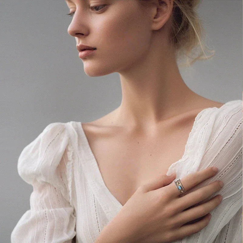 Blue Opal Wide-Band Oval Ring worn on the hand