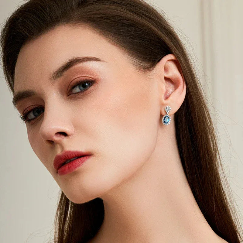 Blue Topaz Oval Halo Drop Earrings angled product view