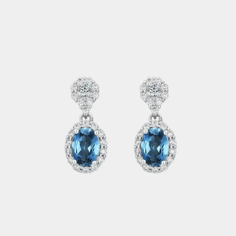Blue Topaz Oval Halo Drop Earrings front product view on a light background