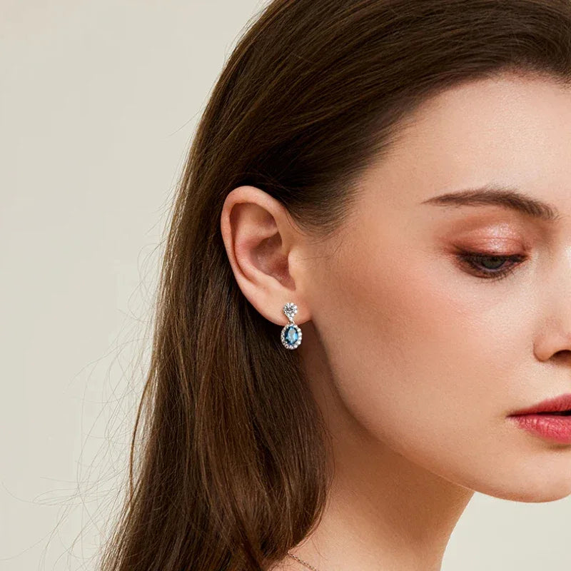 Blue Topaz Oval Halo Drop Earrings side profile view