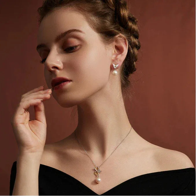 Butterfly Pearl Drop Earrings in Platinum-Plated S925 Silver — model portrait showing the earrings at formal-dress scale