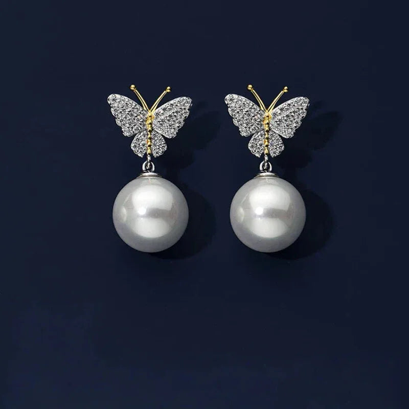 Butterfly Pearl Drop Earrings in Platinum-Plated S925 Silver — pair displayed on a dark background