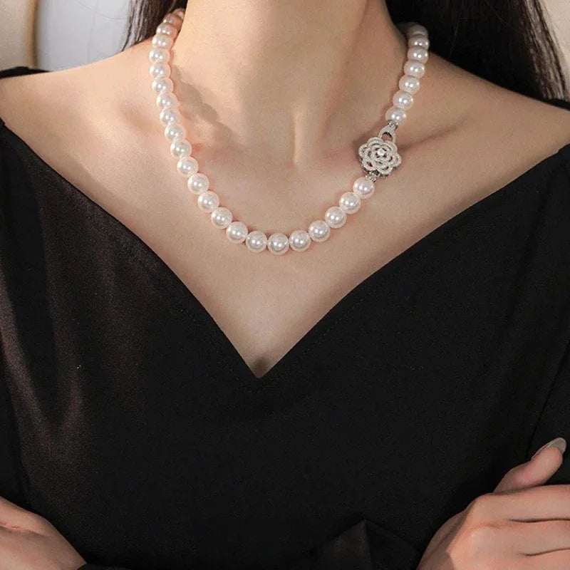 Pearl Strand Necklace with Camellia Clasp — alternate neckline-worn view showing the clasp and strand length