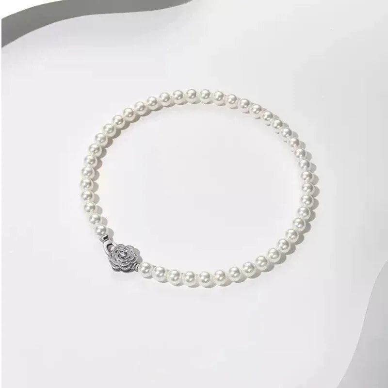 Pearl Strand Necklace with Camellia Clasp — full necklace displayed on white
