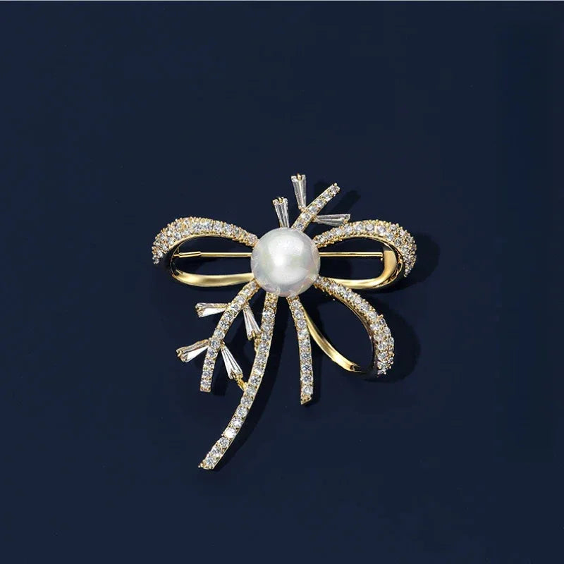 Shell Pearl Bow Brooch — front product view on a dark background