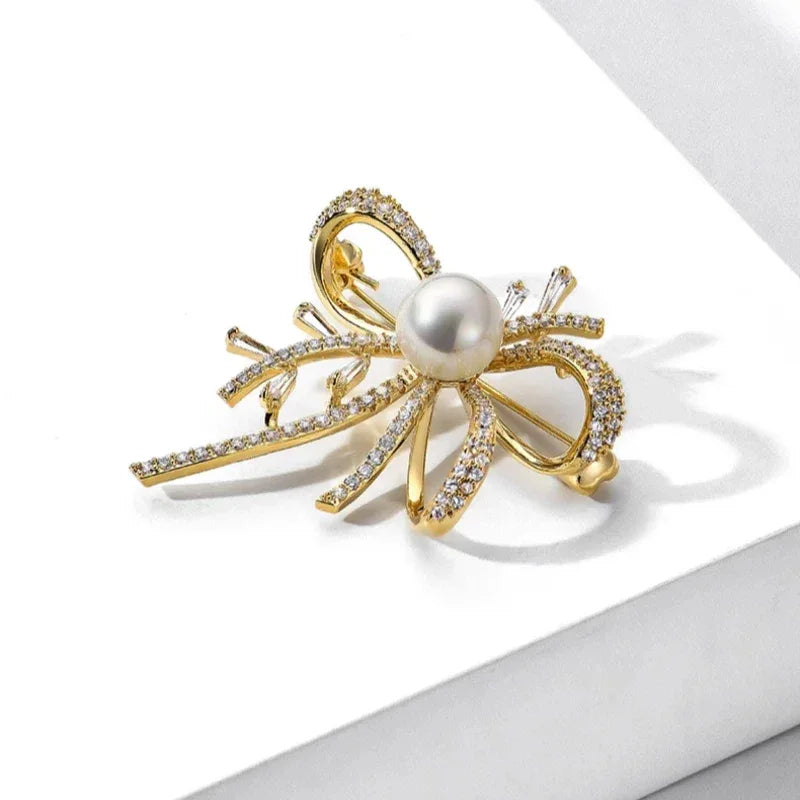 Shell Pearl Bow Brooch — angled product view on white showing the bow loops