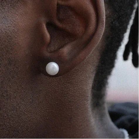 Round Pearl Stud Earrings — right-ear worn close-up showing the pearl scale