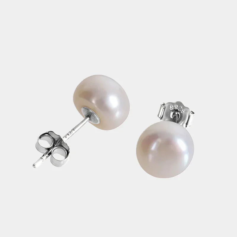 Round Pearl Stud Earrings — angled pair showing the round pearl studs and butterfly backs