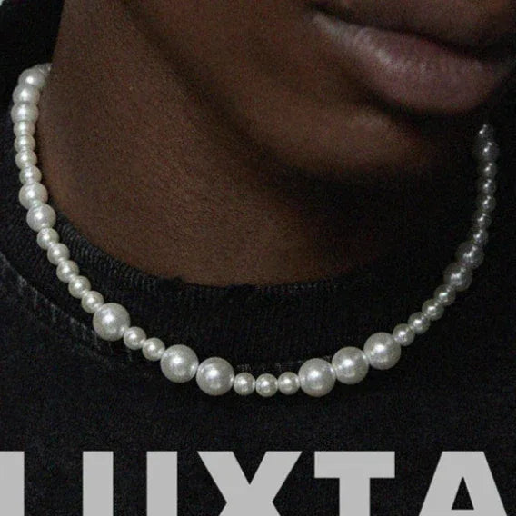 Adjustable Graduated Pearl Strand Necklace — close neckline-worn view over a black graphic shirt