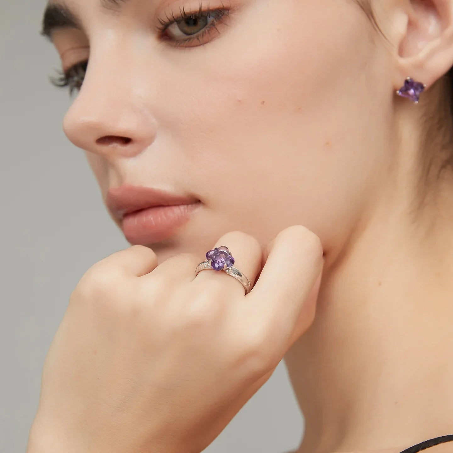 clover-cut amethyst ring worn on the hand from a second angle