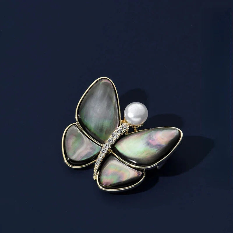 Iridescent Shell Butterfly Brooch with Shell Pearl — front product view on a dark background