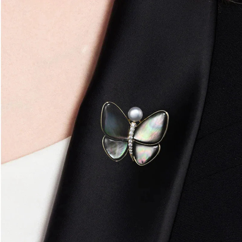 Iridescent Shell Butterfly Brooch with Shell Pearl — close blazer-worn view
