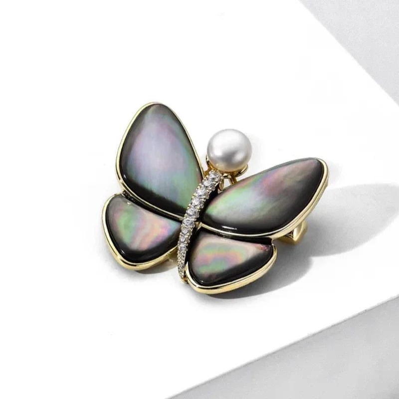 Iridescent Shell Butterfly Brooch with Shell Pearl — angled product view on white