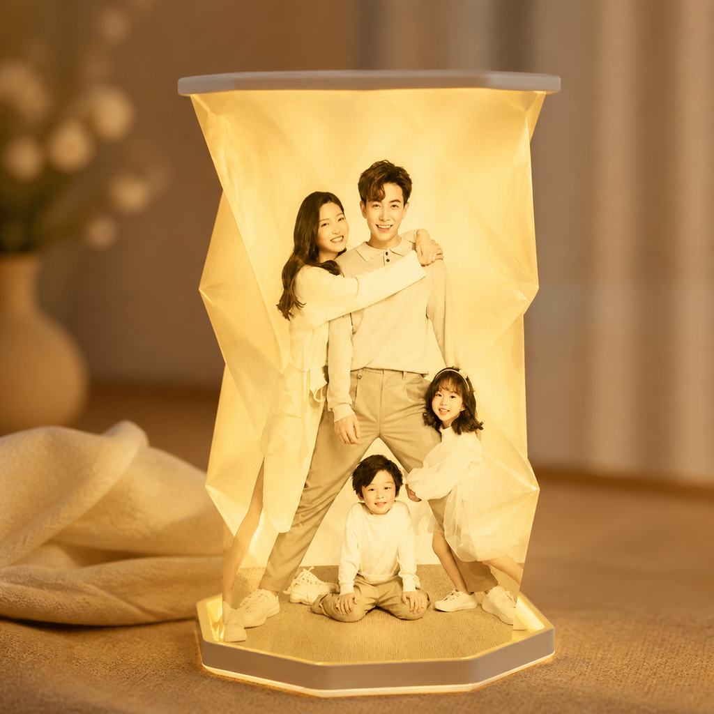 Illuminated twist photo lamp with a family portrait displayed on a warm beige surface