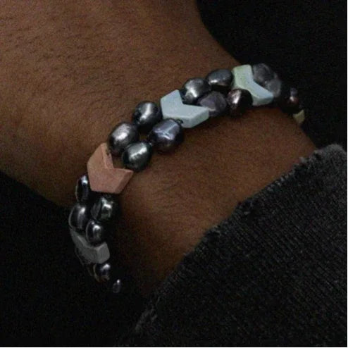 Dark Baroque Pearl Double-Strand Bracelet — wrist-worn close-up under a dark sleeve