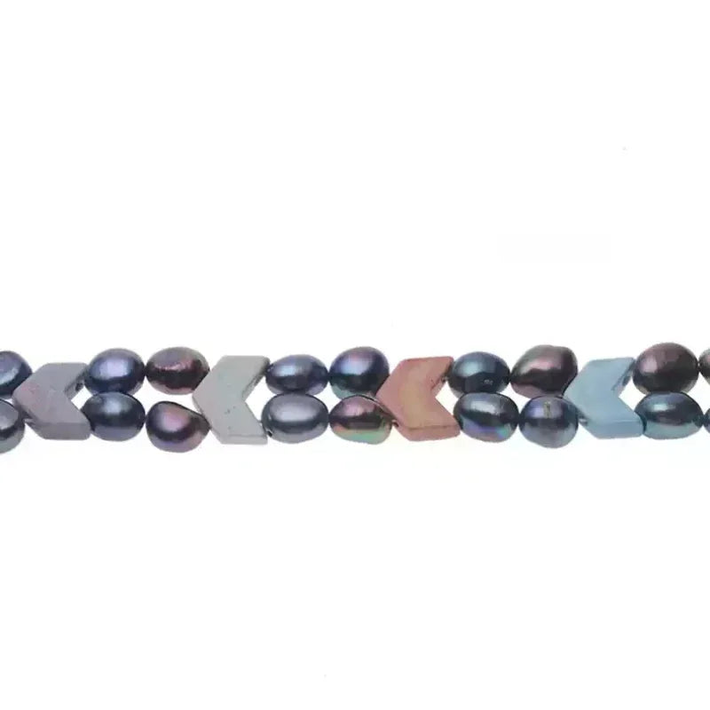 Dark Baroque Pearl Double-Strand Necklace — macro view of overlapping dark pearls and small pastel geometric accents