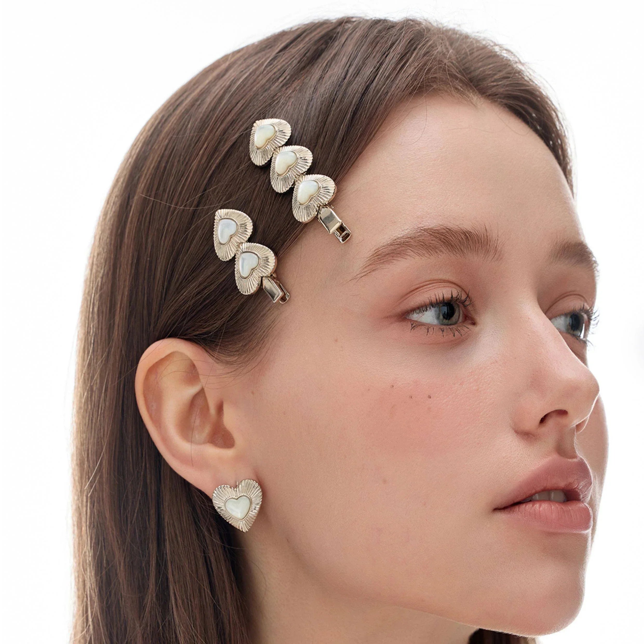 Double Pearl Heart Hair Clip — model portrait wearing the clip with coordinating heart earrings