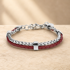 Burgundy leather and silver-tone double-layer bracelet on a warm beige stone surface
