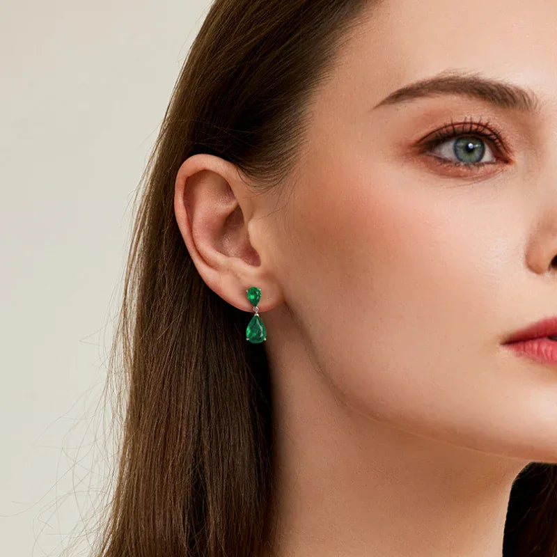 Double Pear-Cut Emerald Drop Earrings styled ear view showing scale