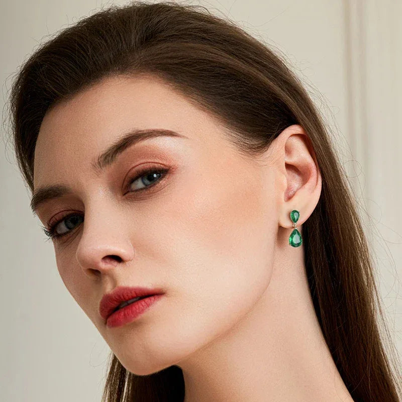 Double Pear-Cut Emerald Drop Earrings worn on the ear from a second angle