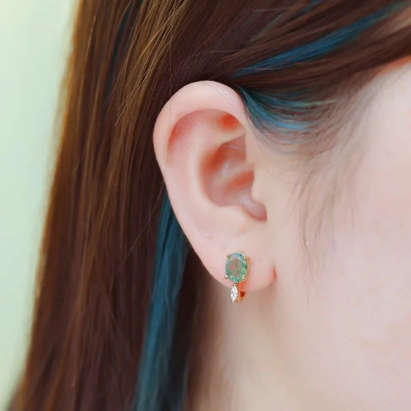 Egg-Shaped Unique Moss Agate Earrings — hand-worn scale view 2