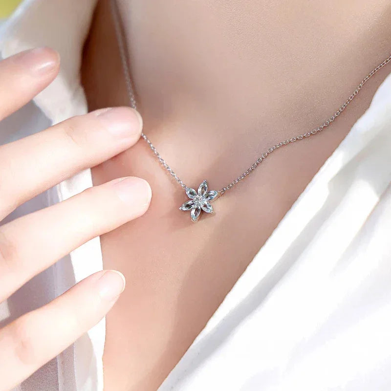 Eight-Point Aquamarine Snowflake Pendant Necklace worn at the neckline from a second angle