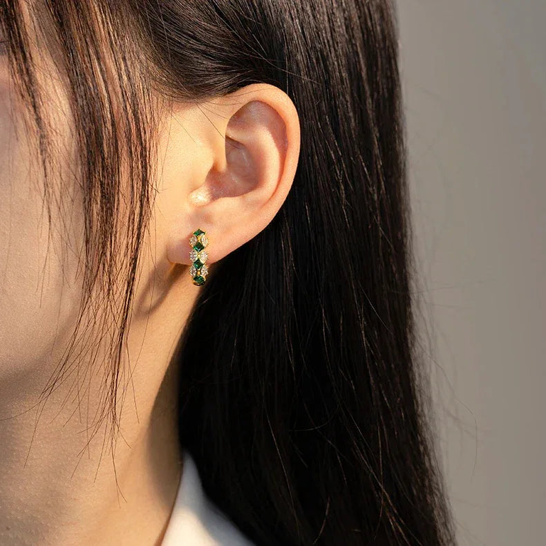Emerald and Marquise Huggie Hoop Earrings paired product view on a dark background