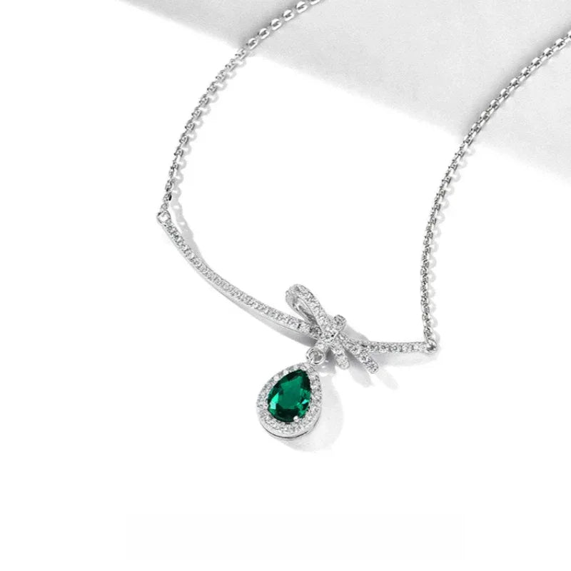 Emerald Bow and Pear Drop Necklace pendant and chain detail on white