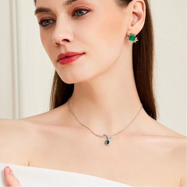 Emerald Bow and Pear Drop Necklace worn at the neckline from a second angle