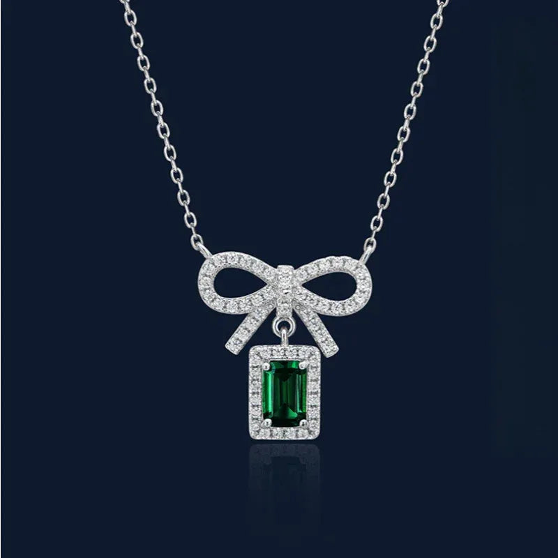 Emerald Bow Pendant Necklace pendant view on a dark background