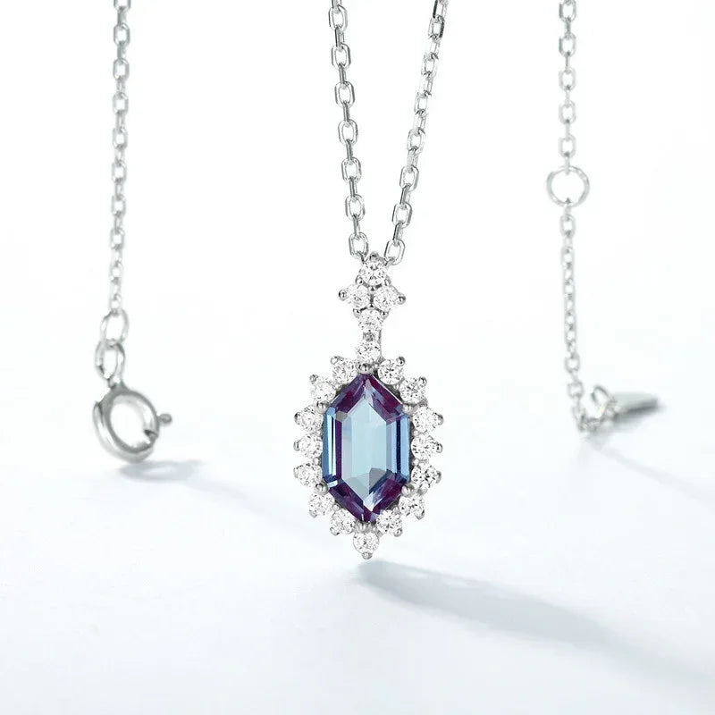Emerald-cut Alexandrite halo pendant necklace, center stone close-up on a white background