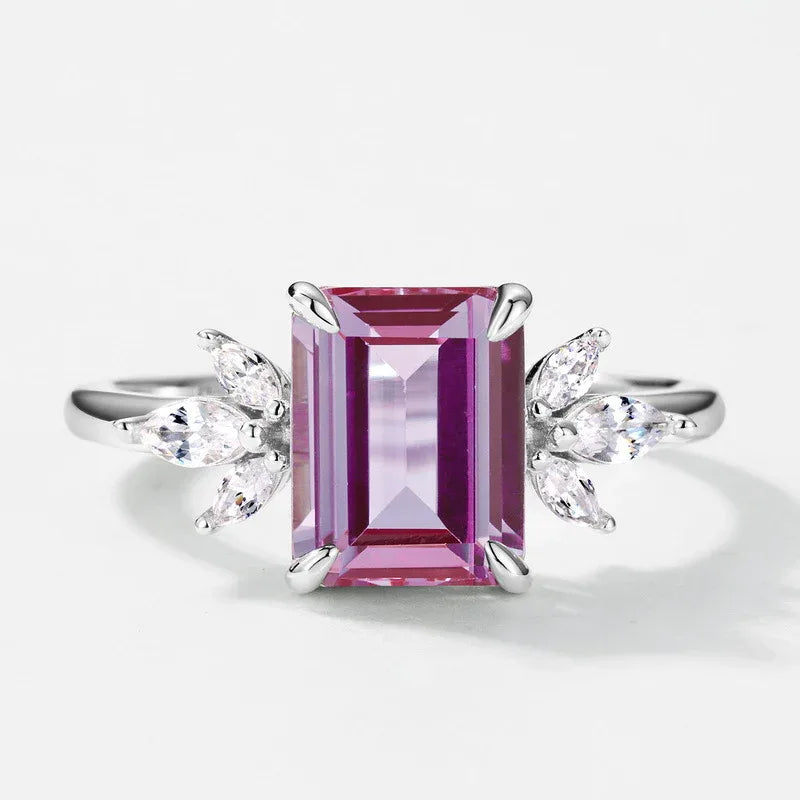 Emerald-cut Alexandrite open ring with leaf side accents, pink-toned Alexandrite view under alternate lighting