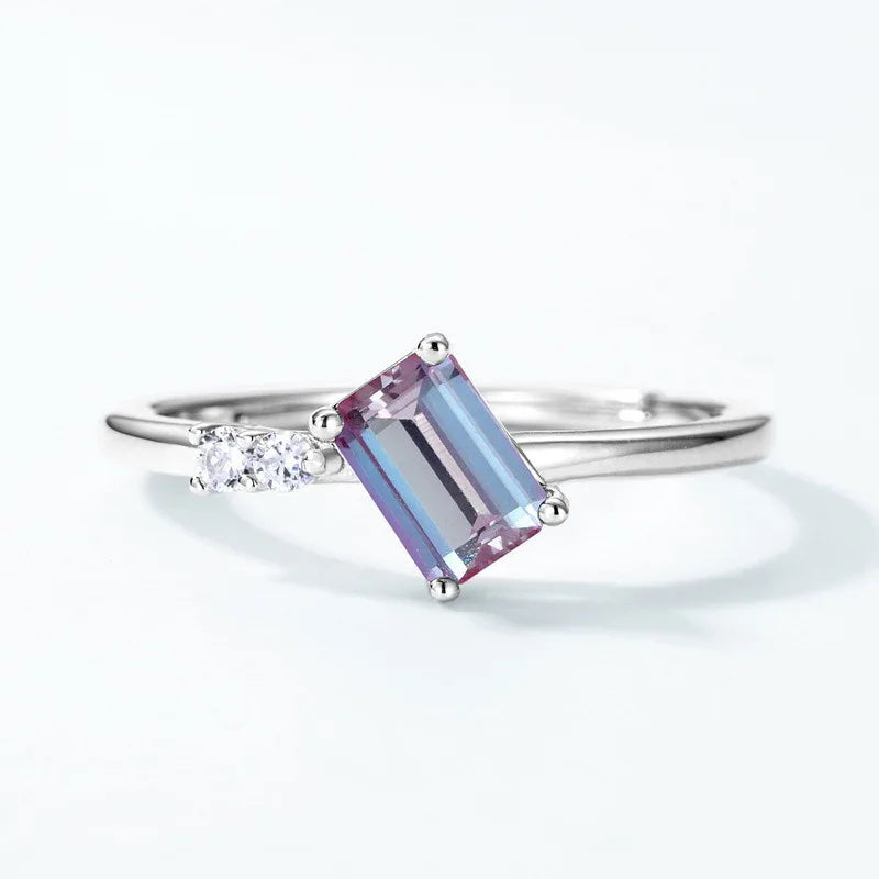 Emerald-cut Alexandrite open band ring with round clear accents, additional product angle on a white background