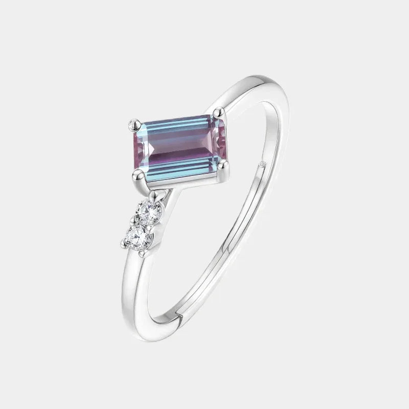 Emerald-cut Alexandrite open band ring with round clear accents, front product view on a white background