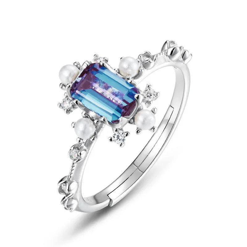 Emerald-cut Alexandrite ring with pearl and clear accents, alternate front product view on a white background