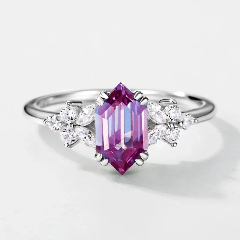 Emerald-cut Alexandrite ring with clear-stone side clusters, pink-toned Alexandrite view under alternate lighting
