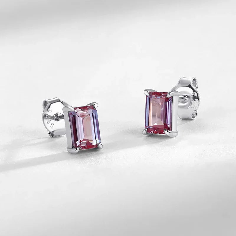 Emerald-cut Alexandrite stud earrings, pink-toned Alexandrite view under alternate lighting