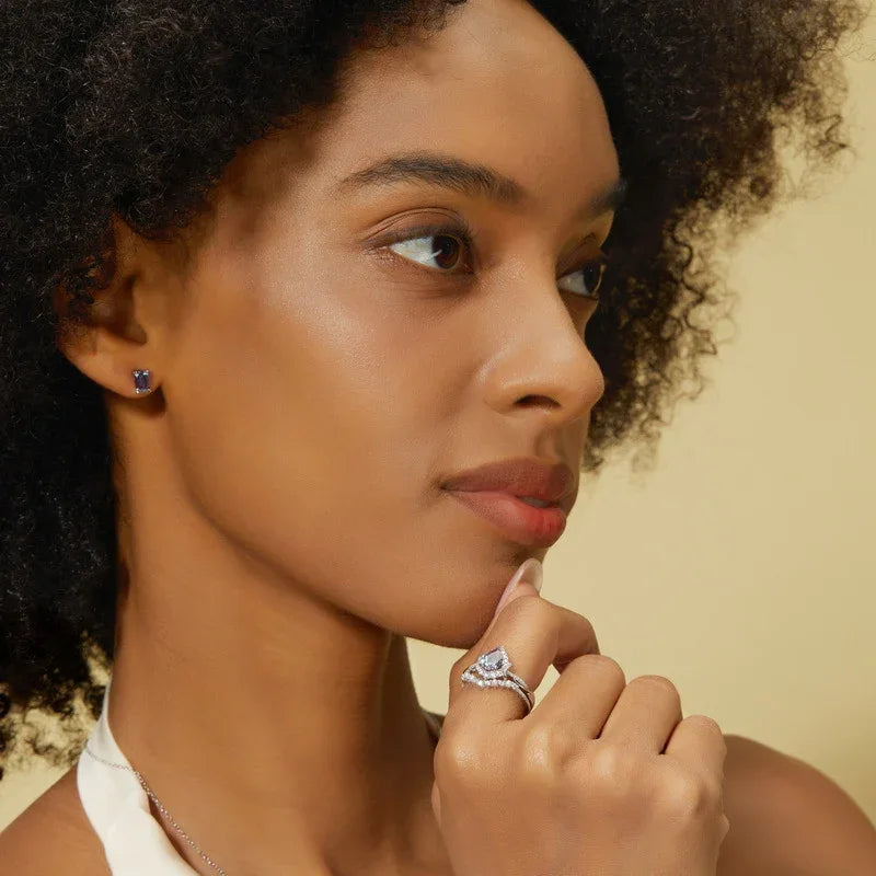 Emerald-cut Alexandrite stud earrings, shown worn by a model for scale
