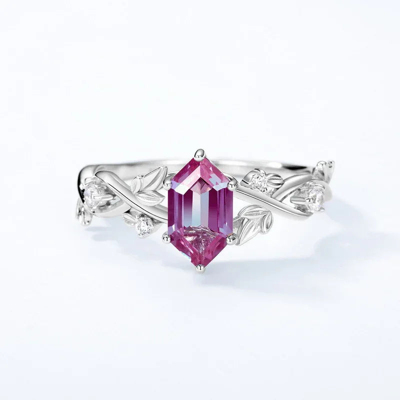 Emerald-cut Alexandrite ring with a vine and leaf band, pink-toned Alexandrite view under alternate lighting