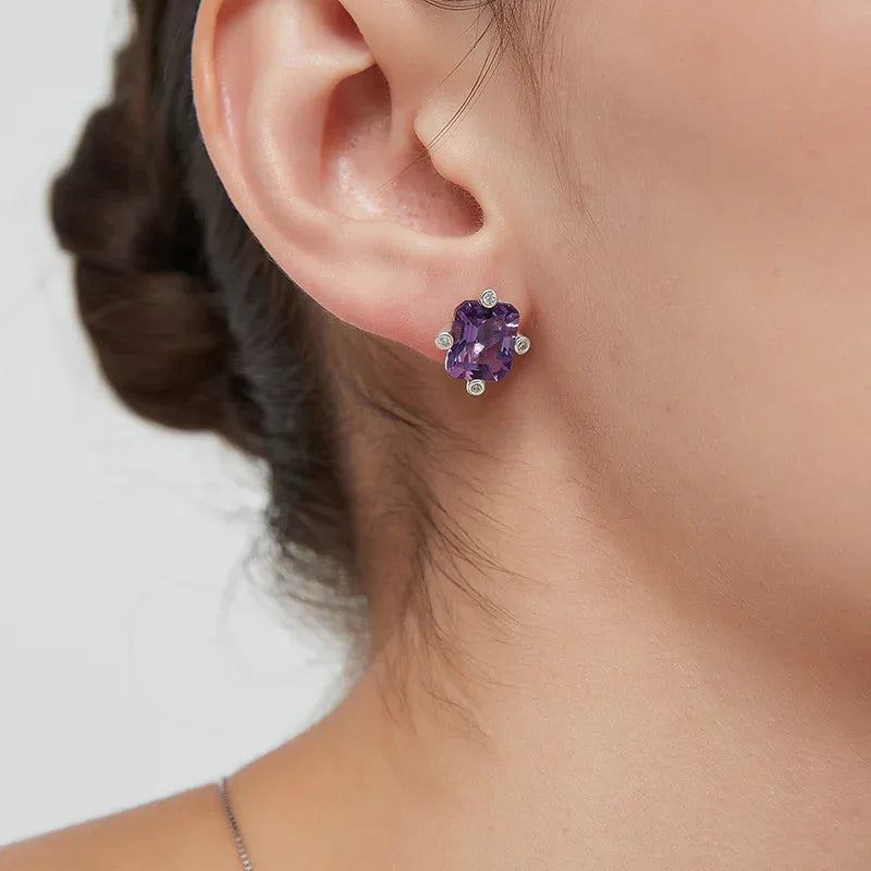 emerald-cut amethyst stud earrings worn on the ear from a second angle