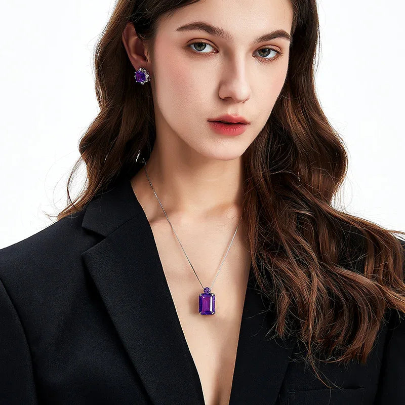emerald-cut amethyst pendant necklace worn at the neckline in a portrait
